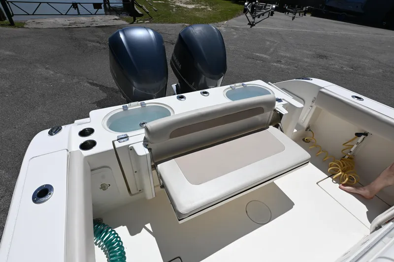 Slide: The Image of 2013 Cobia 296 Center Console boat with dual engines and seating area. - 15