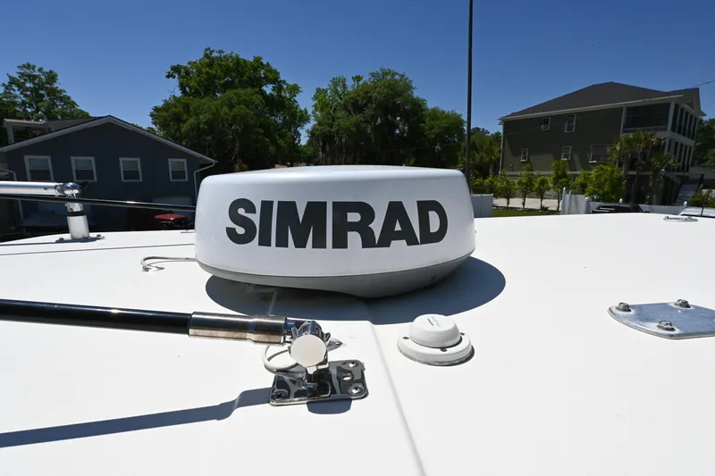 Slide: The Image of Simrad radar on 2013 Cobia 296 Center Console boat under clear blue sky. - 18
