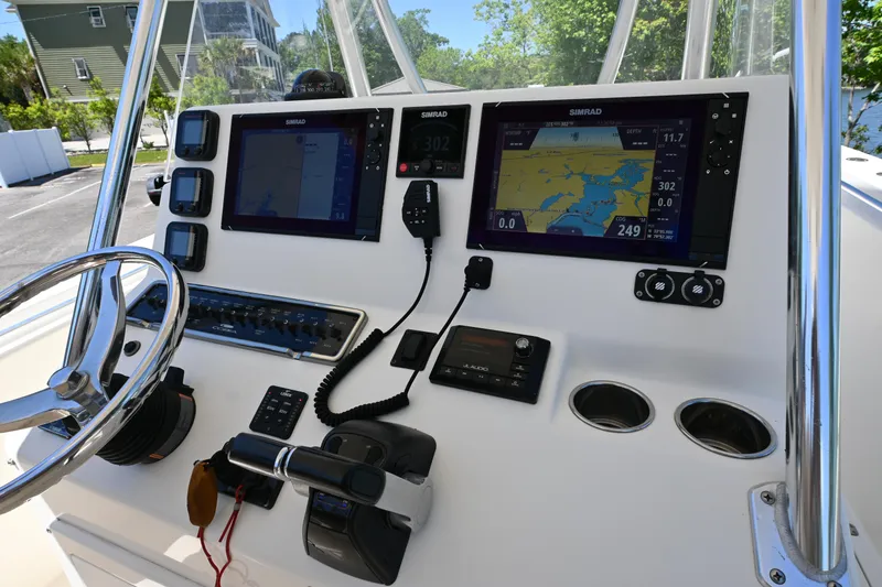 Slide: The Image of 2013 Cobia 296 Center Console dashboard with navigation screens and controls. - 8