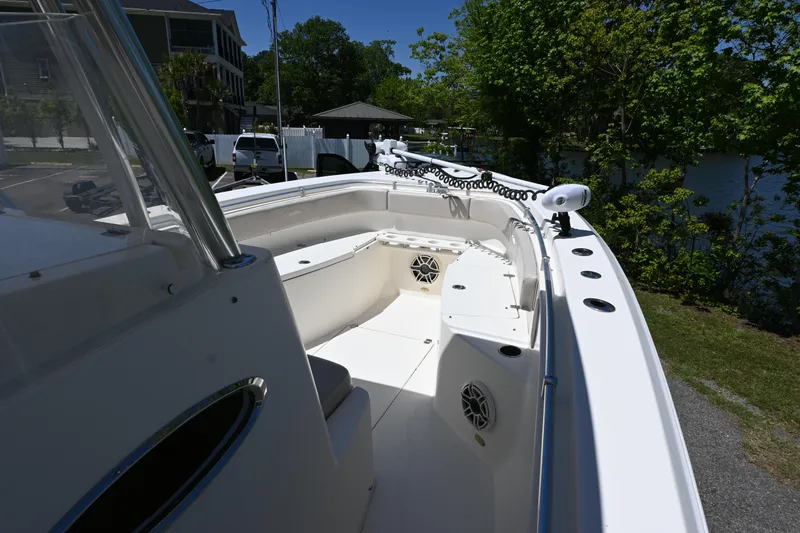 Slide: The Image of 2013 Cobia 296 Center Console boat, spacious deck, sleek design, outdoor setting. - 9