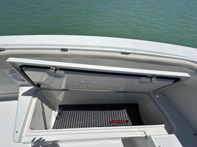 Slide: The Image of Open storage compartment on 2009 Jupiter 29 FS CC boat, near water. - 13