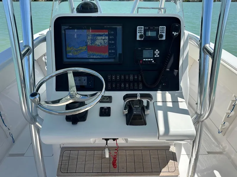 Slide: The Image of 2009 Jupiter 29 FS CC boat console with navigation equipment and steering wheel. - 15