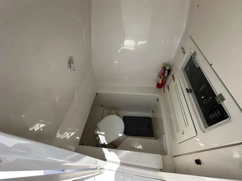 Slide: The Image of 2009 Jupiter 29 FS CC boat interior with toilet and control panel. - 16