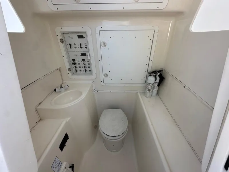 Slide: The Image of 2009 Jupiter 29 FS CC boat interior with toilet, sink, and control panel. - 17