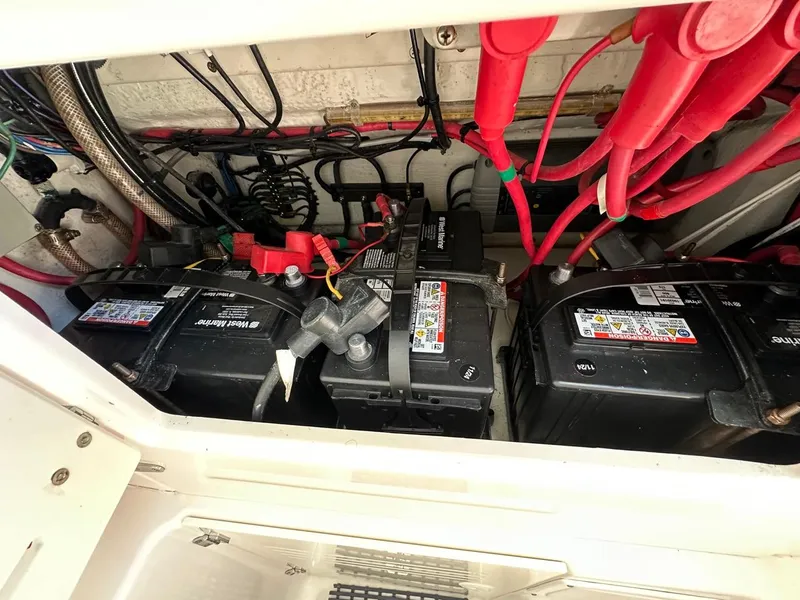 Slide: The Image of Battery compartment of a 2009 Jupiter 29 FS CC boat with wiring and connections. - 18