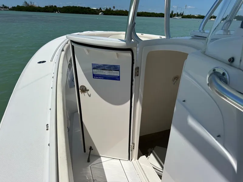 Slide: The Image of 2009 Jupiter 29 FS CC boat interior with open cabin door, on calm water. - 19