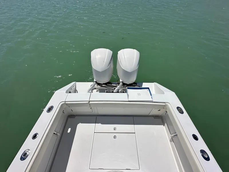 Slide: The Image of 2009 Jupiter 29 FS CC boat with dual outboard motors on calm water. - 22