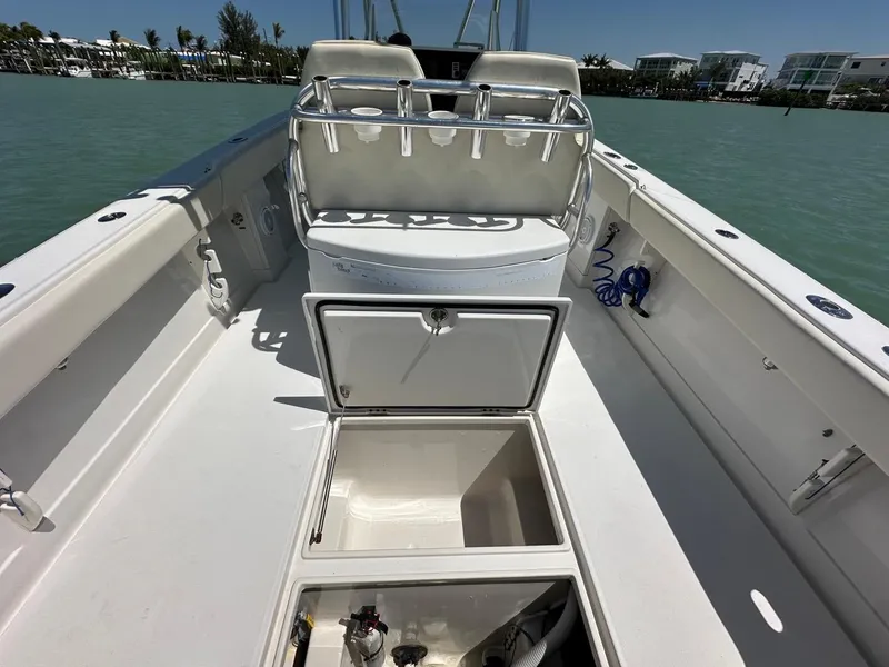 Slide: The Image of 2009 Jupiter 29 FS CC boat interior with open storage compartments on calm water. - 23