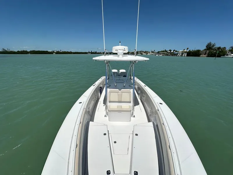 Slide: The Image of 2009 Jupiter 29 FS CC boat on calm water, clear sky, and distant shoreline. - 5