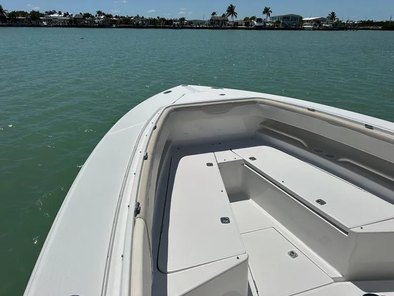 Slide: The Image of 2009 Jupiter 29 FS CC boat on calm water, showcasing spacious deck and seating. - 9