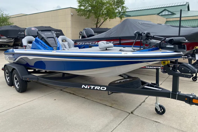 Slide: The Image of 2024 Nitro Z18 Pro boat in blue on a trailer, parked outdoors. - 0
