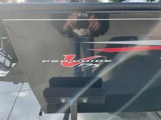 Slide: The Image of 2025 Tracker Pro Guide V-175 WT boat, black exterior with red and white logo detailing. - 2