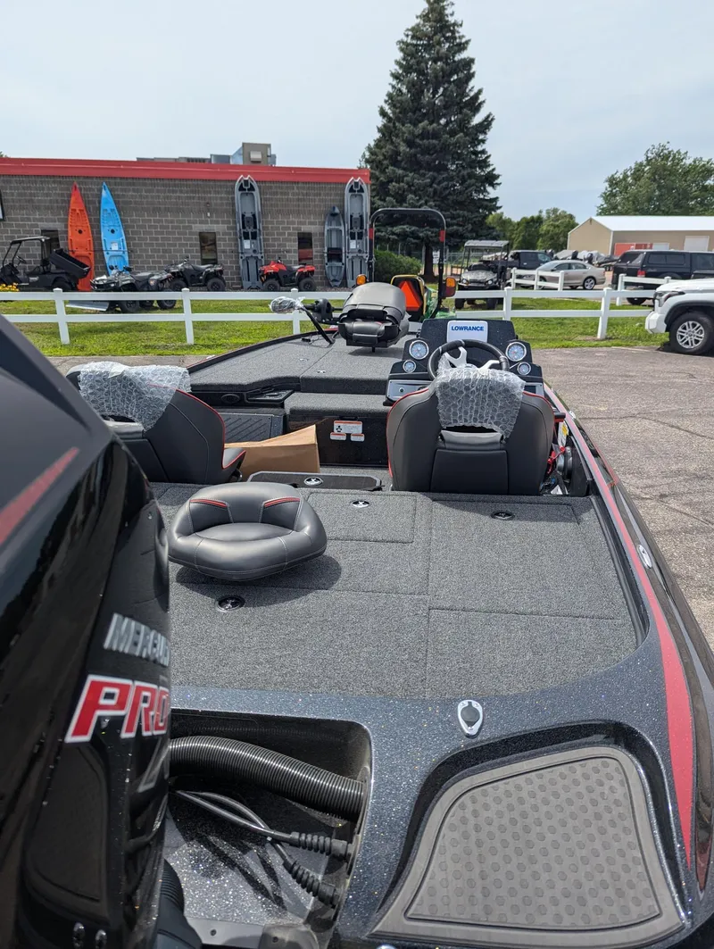 Slide: The Image of 2024 Nitro Z19 boat with spacious deck and modern controls, parked outdoors. - 3