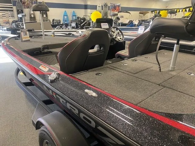 Slide: The Image of 2024 Nitro Z19 boat interior with seating and storage compartments in showroom. - 8