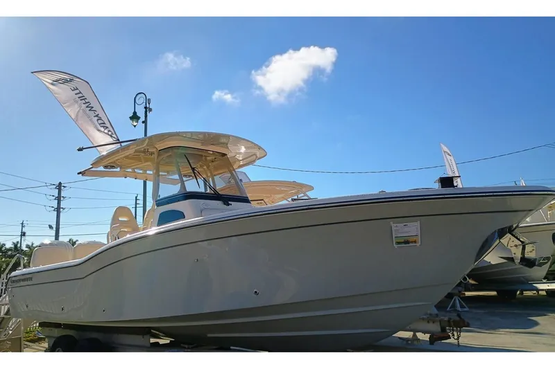 Slide: The Image of 2025 Grady-White 281 Coastal Explorer boat under clear blue sky. - 3