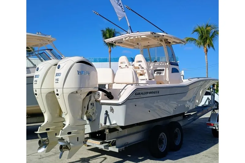 Slide: The Image of 2025 Grady-White 281 Coastal Explorer boat with twin engines on a trailer. - 4