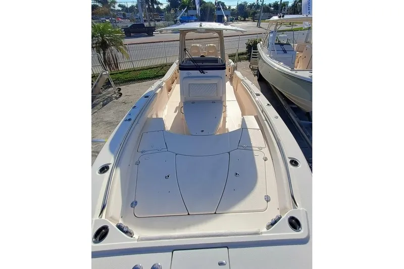 Slide: The Image of 2025 Grady-White 281 Coastal Explorer boat, spacious deck, sleek design, outdoor setting. - 6