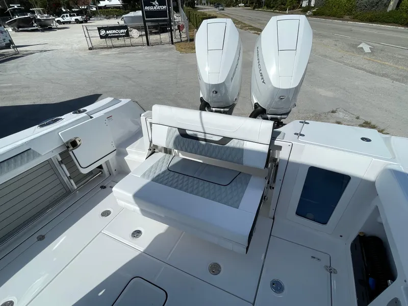 Slide: The Image of 2025 Blackfin 302CC boat with dual Mercury outboard engines, featuring a sleek white deck design. - 14