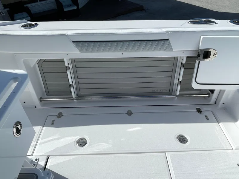 Slide: The Image of 2025 Blackfin 302CC boat deck with storage compartments and sleek design. - 15