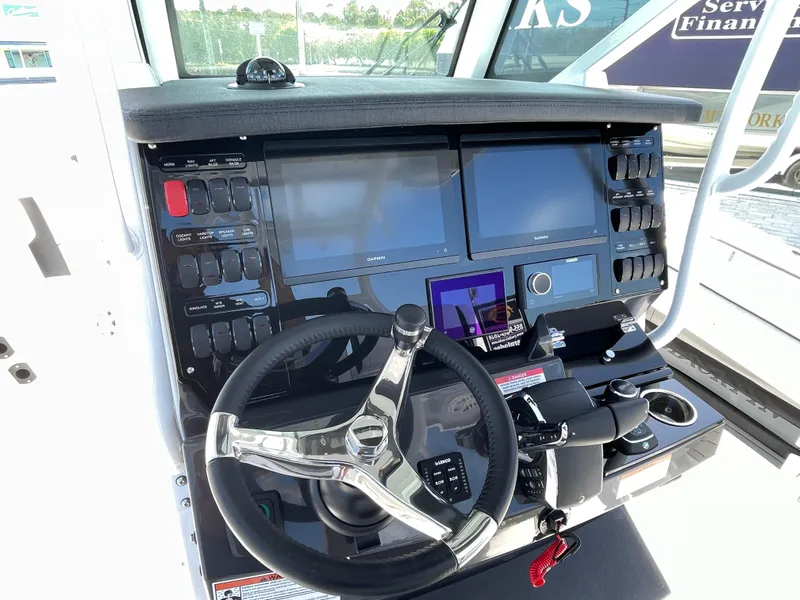 Slide: The Image of 2025 Blackfin 302CC boat dashboard with advanced controls and dual screens. - 16