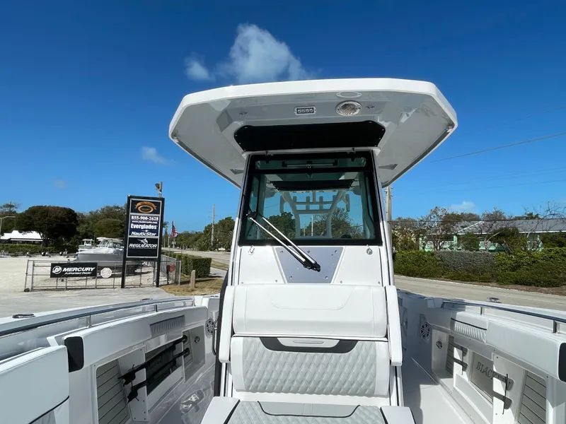Slide: The Image of 2025 Blackfin 302CC boat, front view, clear sky, outdoor display. - 25