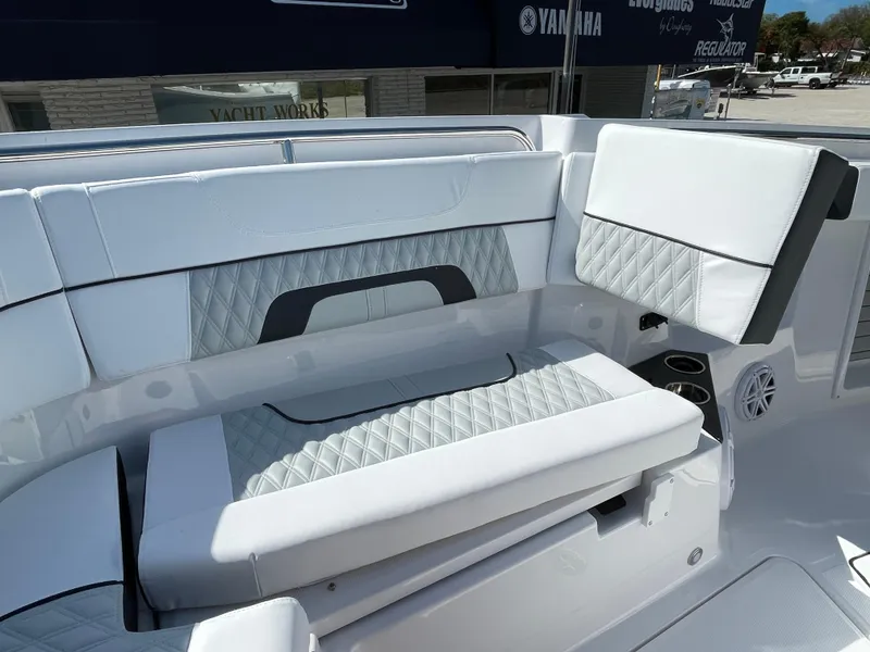 Slide: The Image of 2025 Blackfin 302CC boat interior with white quilted seating and cup holders. - 27