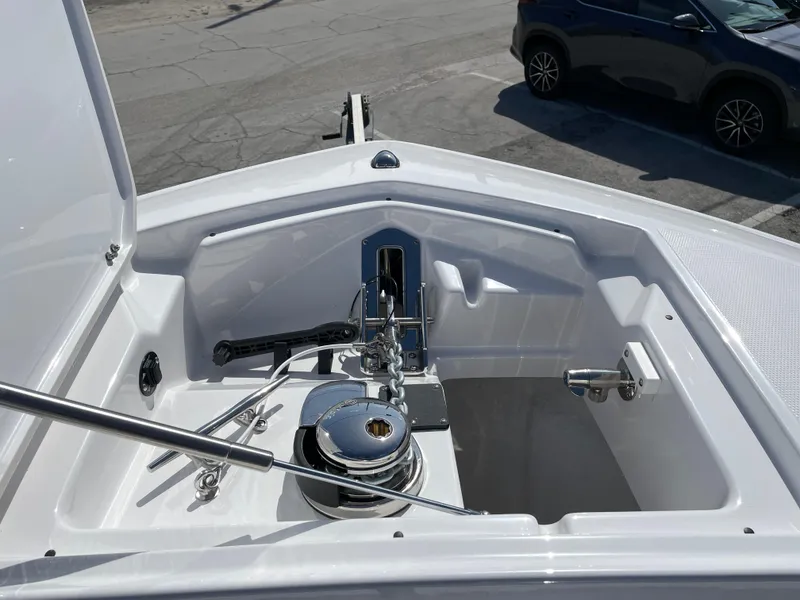 Slide: The Image of 2025 Blackfin 302CC boat anchor compartment with winch and hardware. - 29