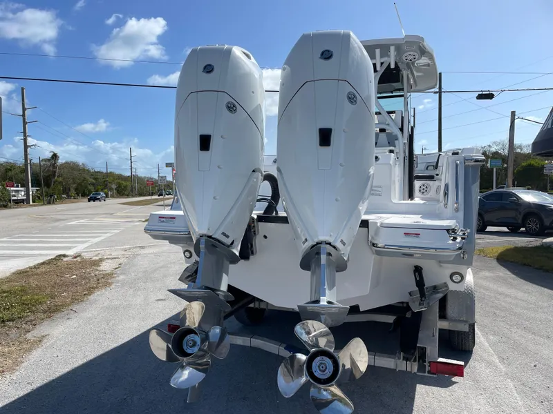 Slide: The Image of 2025 Blackfin 302CC boat with dual outboard engines on a sunny day. - 3