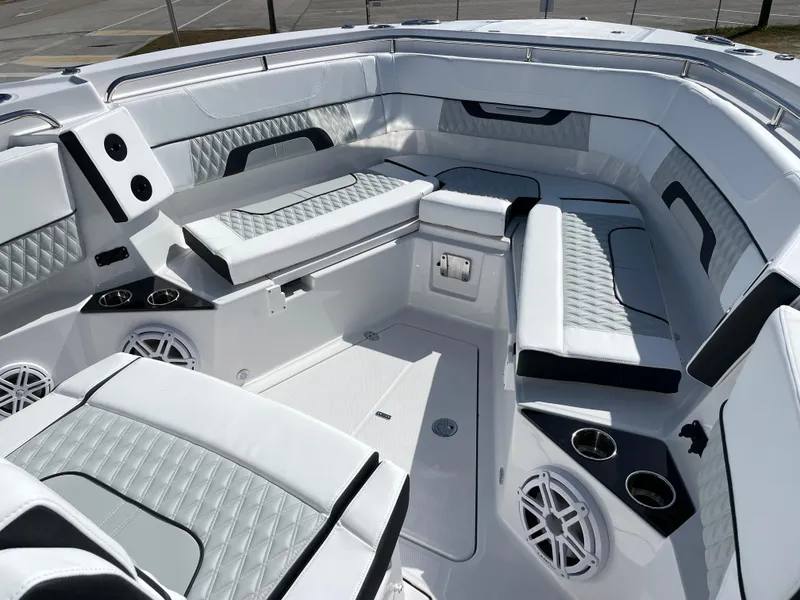 Slide: The Image of Luxurious interior of 2025 Blackfin 302CC boat with cushioned seating and cup holders. - 30