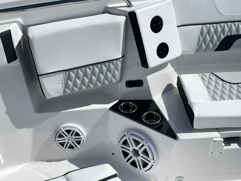 Slide: The Image of 2025 Blackfin 302CC boat interior with white cushioned seating and built-in speakers. - 32