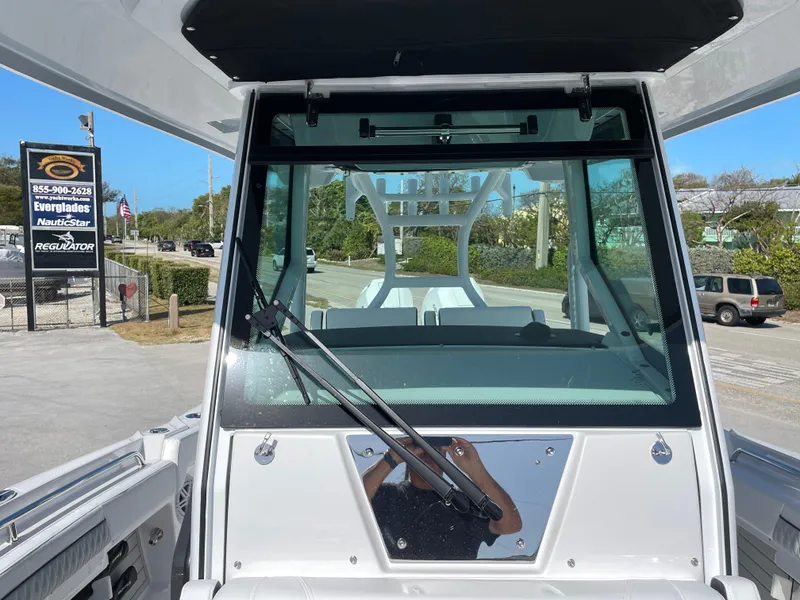 Slide: The Image of 2025 Blackfin 302CC boat windshield view with wiper, outdoor setting. - 34