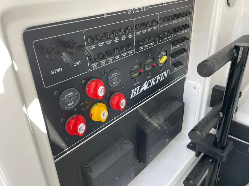 Slide: The Image of Control panel of 2025 Blackfin 302CC boat with switches and dials. - 39