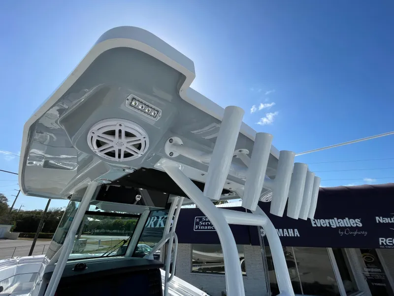 Slide: The Image of 2025 Blackfin 302CC boat with rod holders and speaker, under clear blue sky. - 40