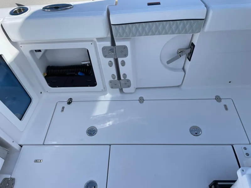 Slide: The Image of 2025 Blackfin 302CC boat deck with storage compartments and sleek design. - 43