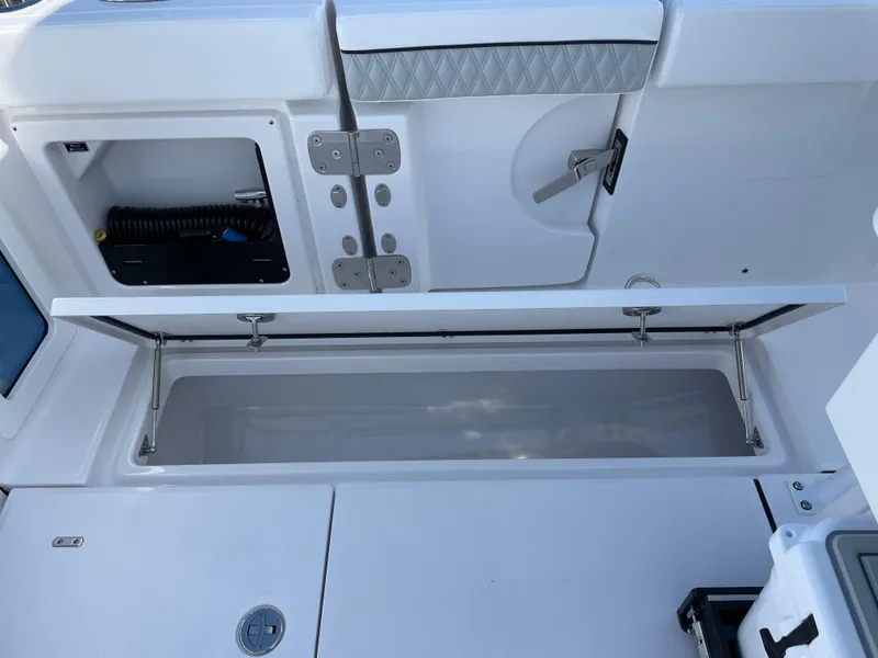 Slide: The Image of 2025 Blackfin 302CC boat storage compartment with open hatch and visible interior. - 44