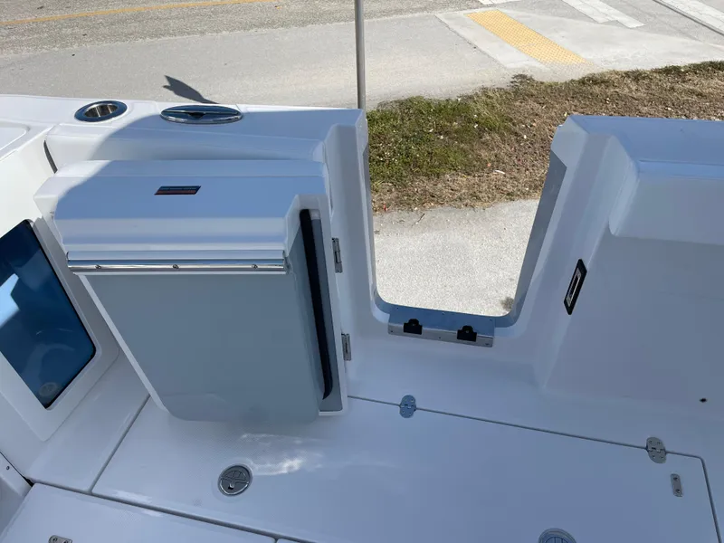 Slide: The Image of 2025 Blackfin 302CC boat interior with storage compartment and seating area. - 45