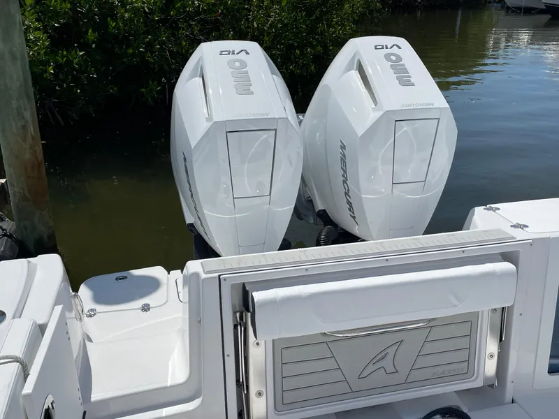 Slide: The Image of 2025 Blackfin 302CC boat with twin outboard engines docked by the water. - 47
