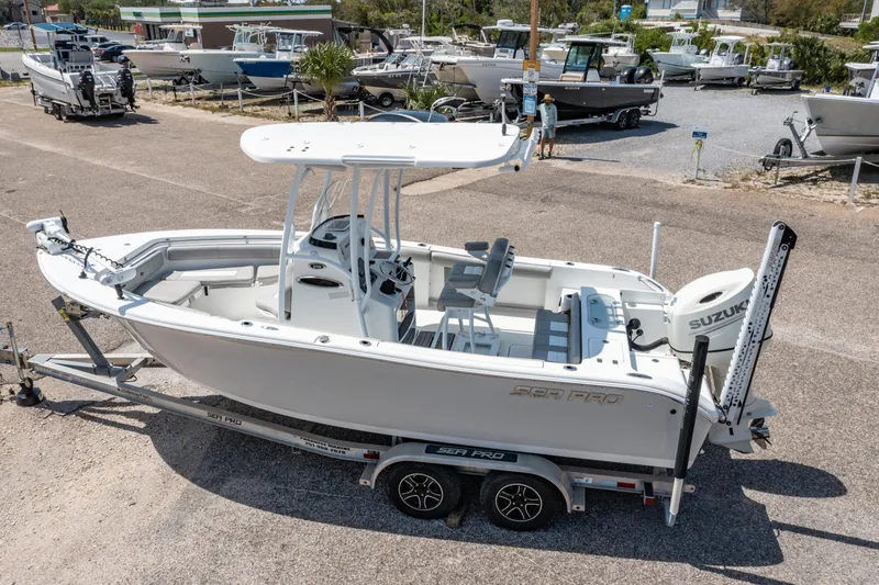 Slide: The Image of 2019 Sea Pro 219 DLX boat on trailer, parked in a marina. - 1
