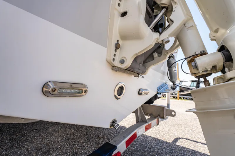 Slide: The Image of 2019 Sea Pro 219 DLX boat stern detail with trailer, showcasing engine and fittings. - 10