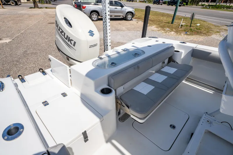 Slide: The Image of 2019 Sea Pro 219 DLX boat interior with Suzuki engine, featuring seating and storage compartments. - 11