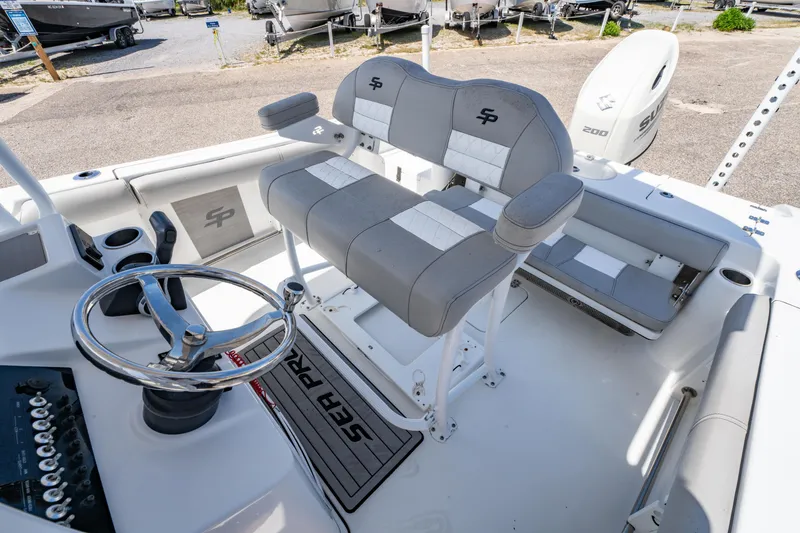 Slide: The Image of 2019 Sea Pro 219 DLX boat interior with dual seating and steering wheel. - 13