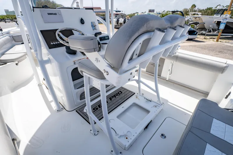 Slide: The Image of 2019 Sea Pro 219 DLX boat interior with helm and seating area. - 14