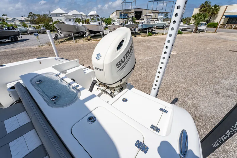 Slide: The Image of 2019 Sea Pro 219 DLX boat with Suzuki 200 engine, docked in a marina. - 15