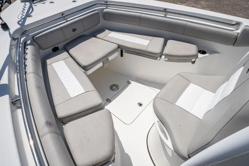 Slide: The Image of 2019 Sea Pro 219 DLX boat interior with cushioned seating and storage compartments. - 22