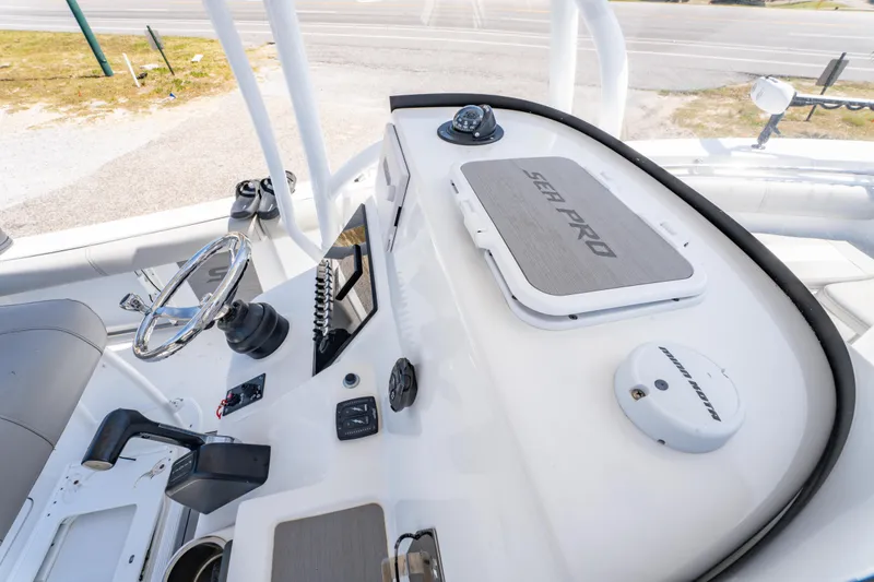 Slide: The Image of 2019 Sea Pro 219 DLX boat dashboard with steering wheel and navigation controls. - 25