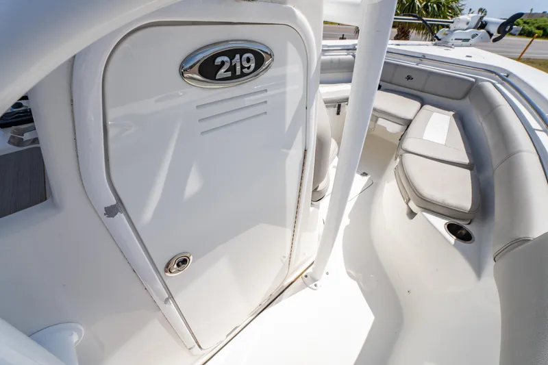 Slide: The Image of 2019 Sea Pro 219 DLX boat interior with seating and storage compartment. - 26