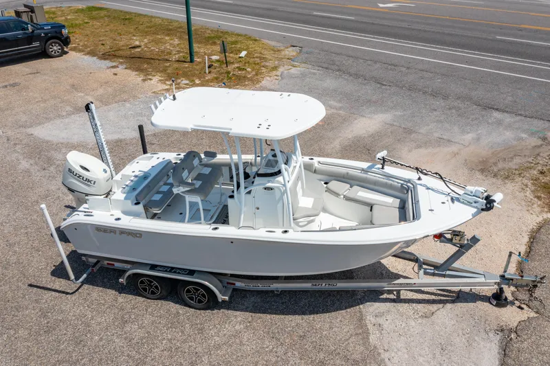 Slide: The Image of 2019 Sea Pro 219 DLX boat on trailer, parked near a road. - 27