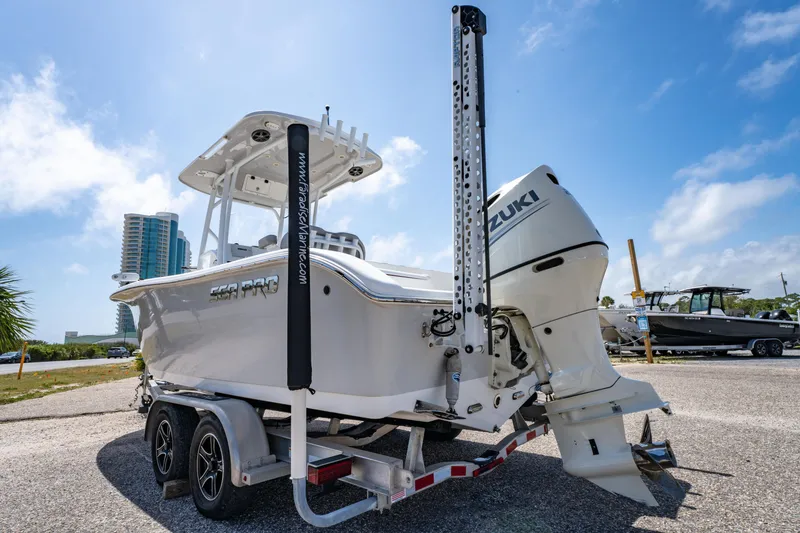 Slide: The Image of 2019 Sea Pro 219 DLX boat on trailer with Suzuki outboard motor, parked outdoors. - 5