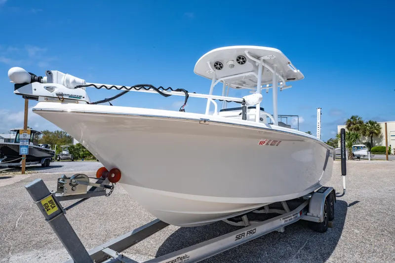 Slide: The Image of 2019 Sea Pro 219 DLX boat on trailer under clear blue sky. - 7