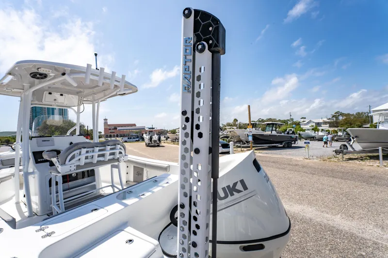 Slide: The Image of 2019 Sea Pro 219 DLX boat with Suzuki engine, docked under clear blue sky. - 9